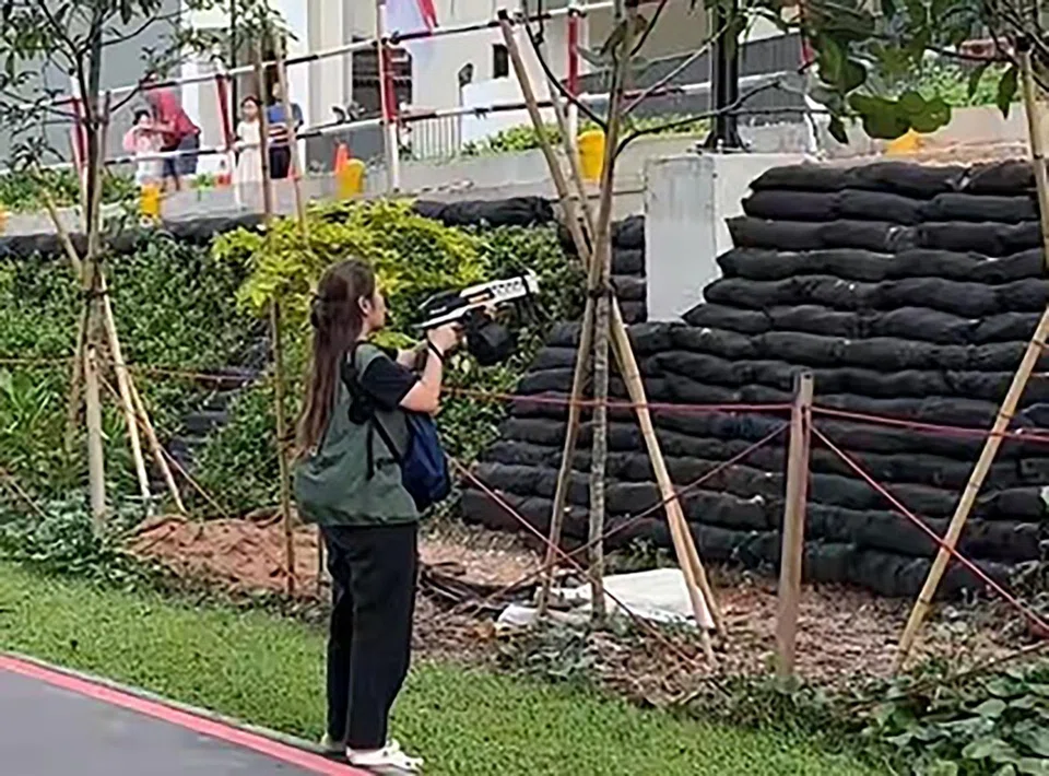 An NParks contractor using water gel blasters to drive the monkeys out of a HDB estate in Punggol on Aug 2.