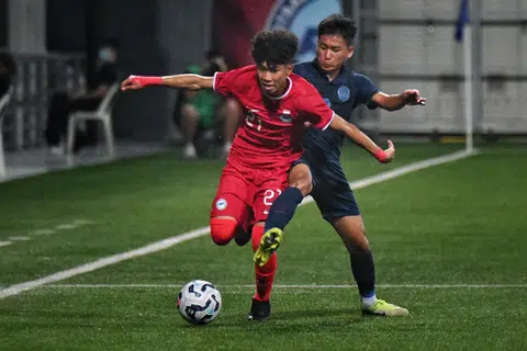 Singapore's Ahmad Izzan Rifqi vying for the ball with Cambodia's Sanh Sokchea in a Lion City Cup Under-16 boys' match at the Jalan Besar Stadium on July 11.
