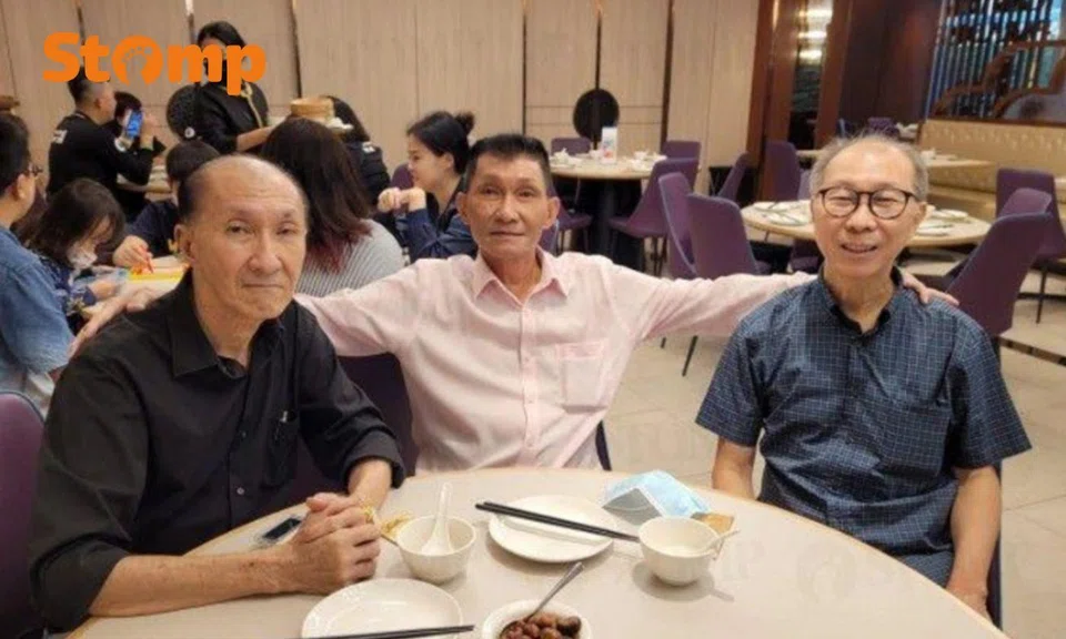 Three men smiling in a restaurant