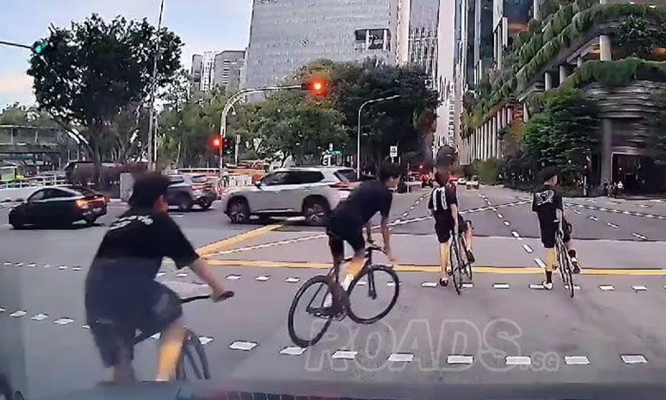 Cyclists recklessly weave through traffic without helmets in Chinatown