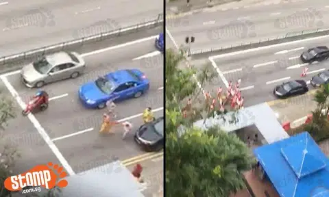 Members of procession run on road -- despite oncoming traffic at Geylang Bahru