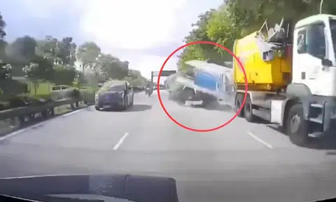 A large lorry rear-ends a smaller lorry, which in turn crashes into the back of another lorry, which subsequently flips onto its side as it lands in the next lane.