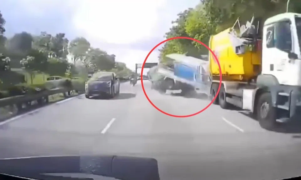 A large lorry rear-ends a smaller lorry, which in turn crashes into the back of another lorry, which subsequently flips onto its side as it lands in the next lane.