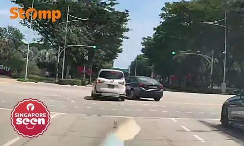 Two cars kiss at Marina Boulevard