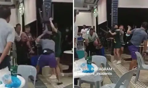 The video at first shows a beer promoter hitting a man with a plastic stool, and a man in black grabbing a man in blue and raining blows on him. 