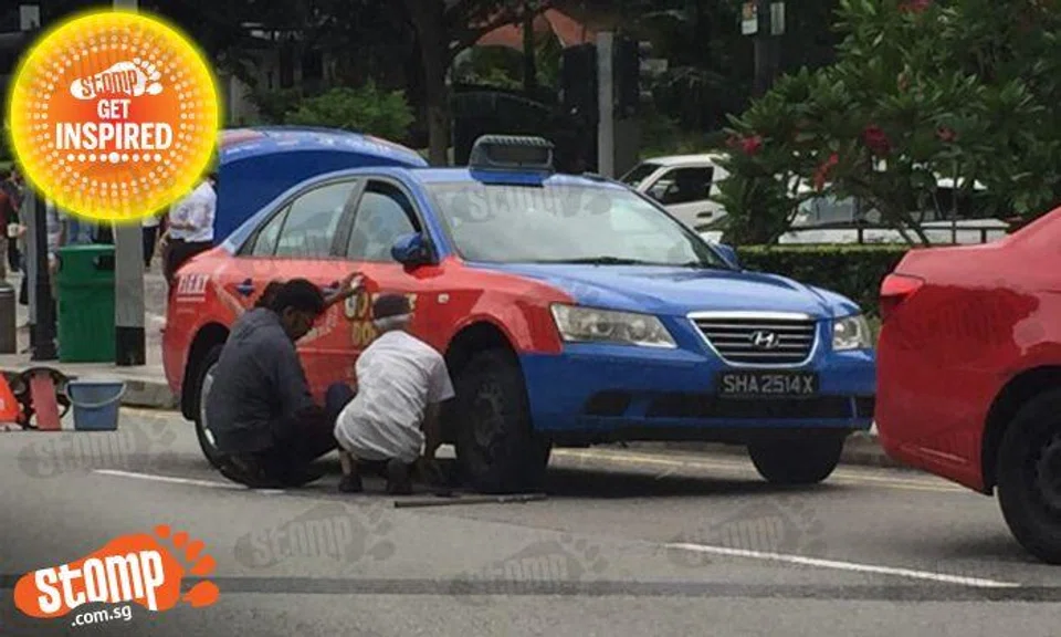 So nice to see taxi driver help fellow cabby fix his wheel -- despite being from another company