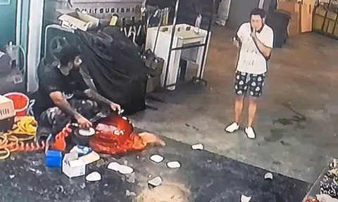 While the CCTV camera didn’t capture any sound, the handyman’s work must’ve caused quite the ruckus as the man circles back to him. He then puts a finger to his mouth, signalling him to “be quiet”.