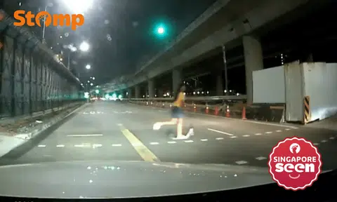 girl rides scooter across red pedestrian light