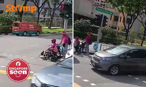 Elderly man pushes woman in wheelchair during red light, gets stuck in middle of busy road