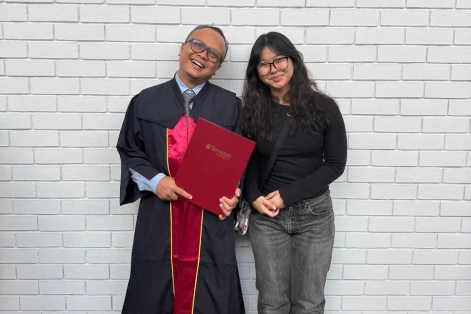 Mr Shaiful Khairi Mohammed Johari with his daughter Nur Amalina on his graduation day.