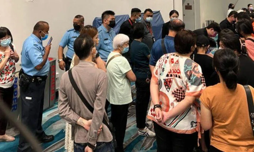 Pictures published on Monday in Chinese-language daily Shin Min Daily News showed long queues at the Marina Bay Cruise Centre, while others were sitting around waiting with their luggage.