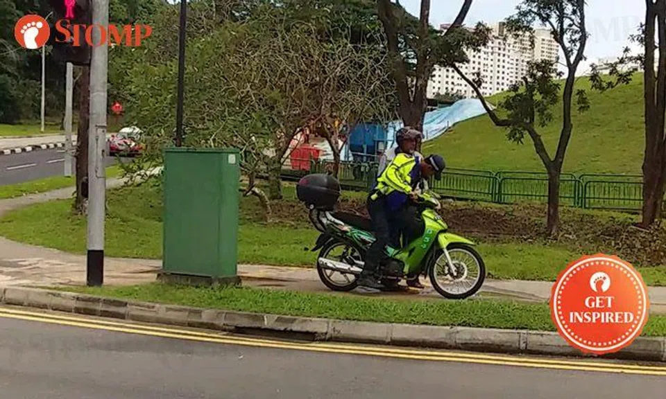 Officer helps man kick-start motorcycle after it stalls along Marsiling Road