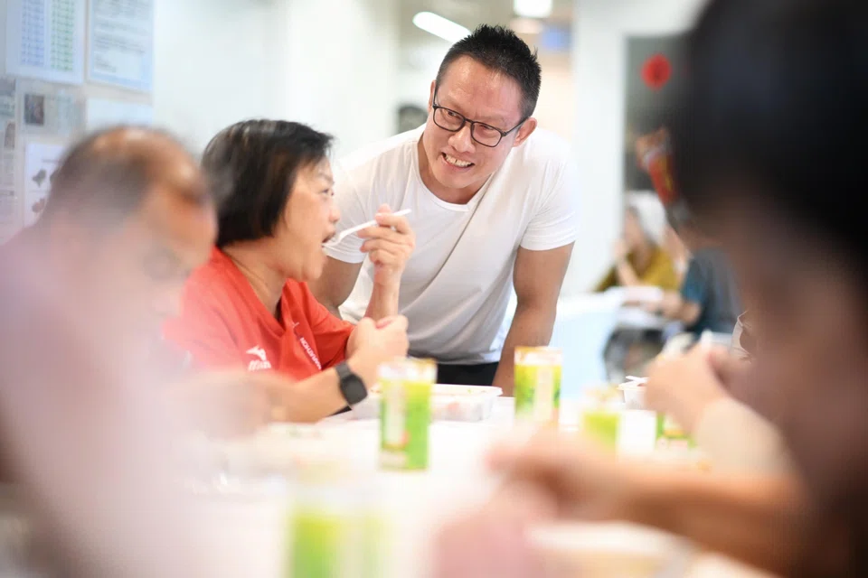 Mr Roger Tan speaking to seniors after distributing lunch with former inmates and volunteers to the elderly at THK Active Ageing Centre in Cassia Crescent on June 4.