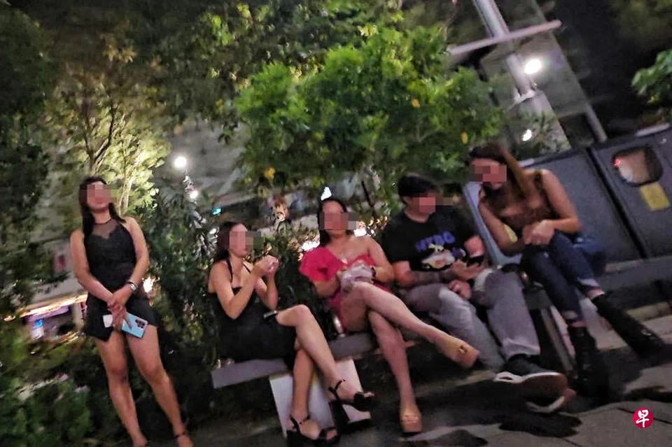 A scantily clad woman seen approaching passers-by outside Forum The Shopping Mall along Orchard Road.