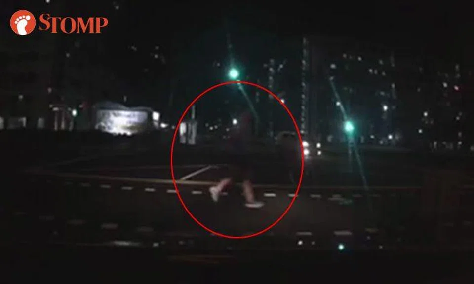 So dark, and jogger crosses road without looking out for traffic during green light