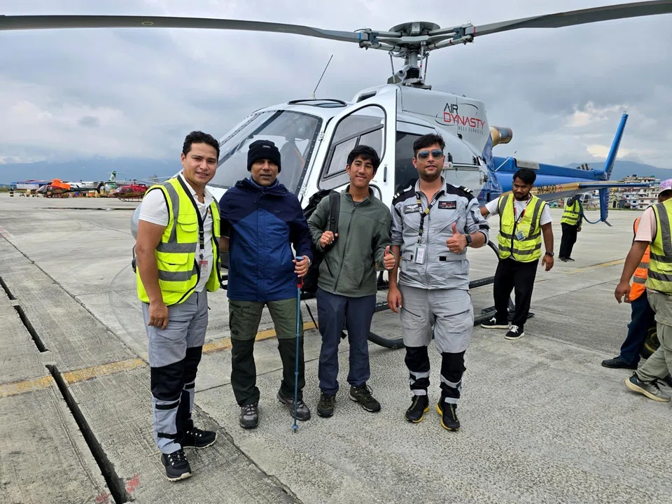 Mr Roberts and his son David with the pilots who managed to fly them to Kathmandu safely. 