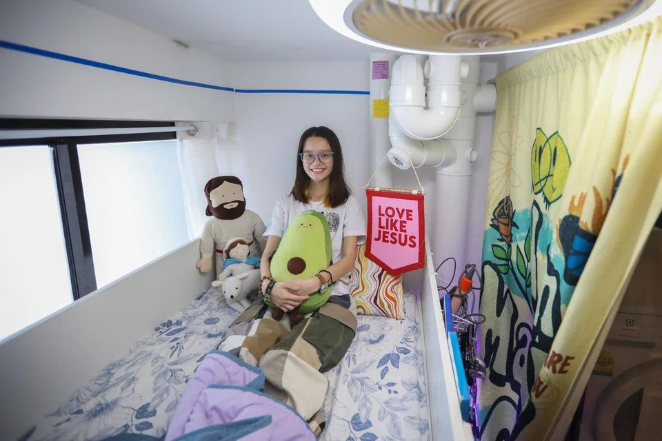 Ms Sasha Marie Shelley on her bunk bed in her bedroom, which was originally the service yard of her family’s flat.
