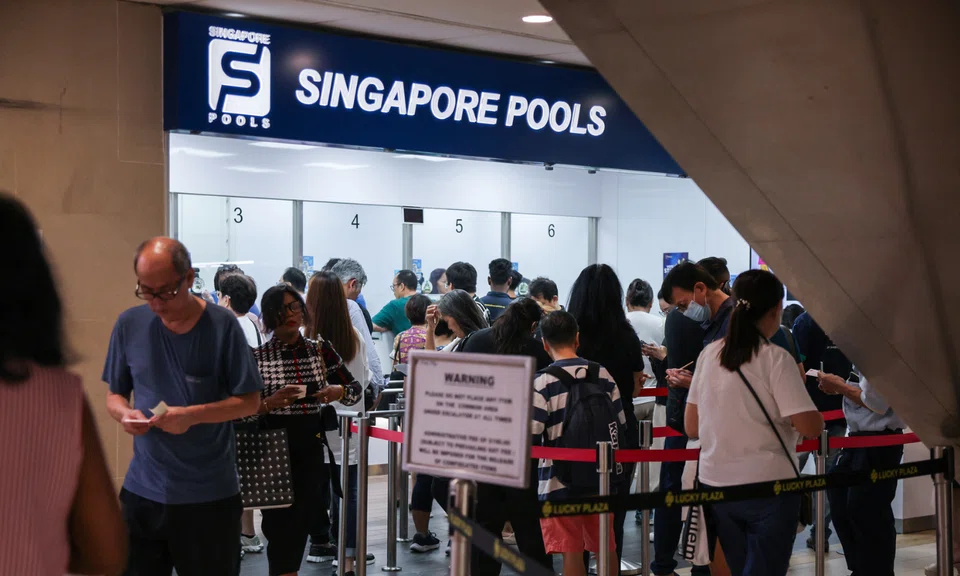 People queue for Toto at the Singapore Pools branch in Lucky Plaza on Nov 6, 2025.