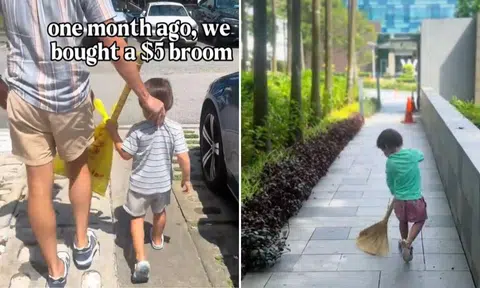 Toddler holding broom