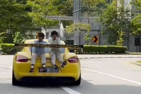 Two children filmed 'cruising' on trunk of moving Porsche