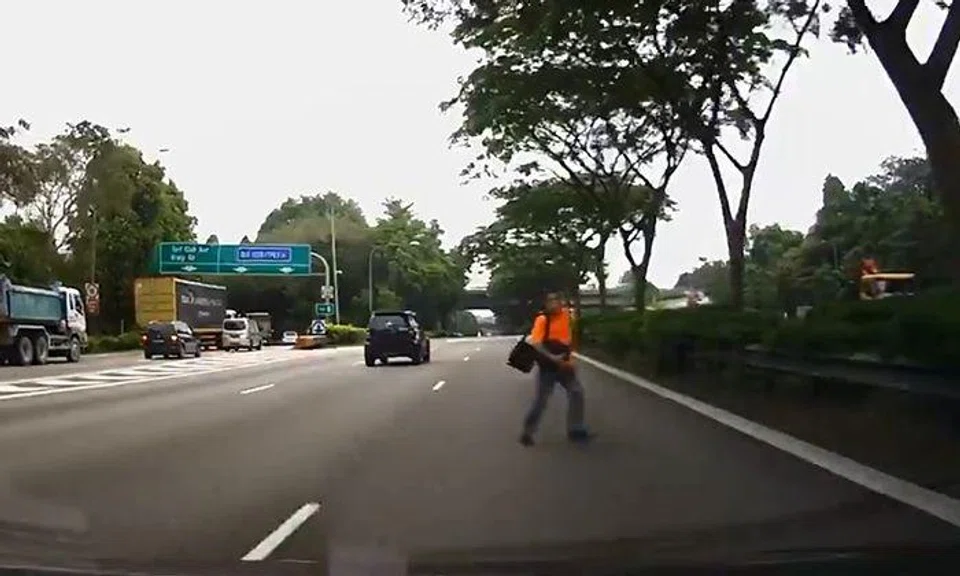 Near miss as alert driver swerves to avoid man walking on expressway