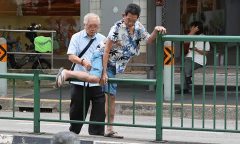 Elderly men scale railings, dodge traffic to reach betting centre at Rangoon Road