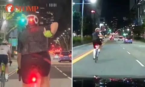 Angry cyclist flashes middle finger at driver 3 times, uses phone while riding at Orchard Road
