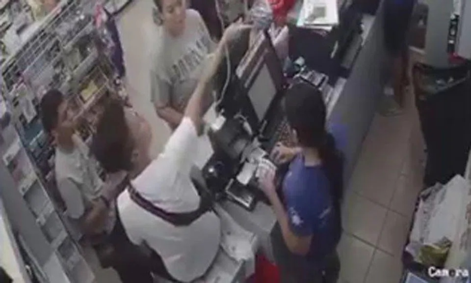 Youth sits on counter and shouts at minimart staff after being rejected sale of cigarettes