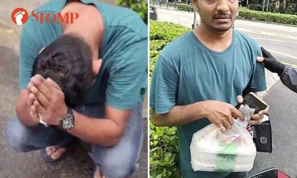 A man broke down in tears after he was accused of being an illegal food delivery at Scotts Road.