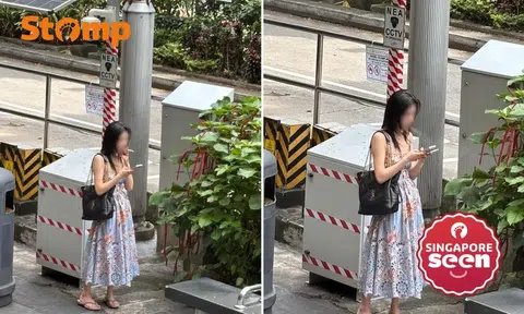 woman smokes in front of nea cctv camera outside lucky plaza