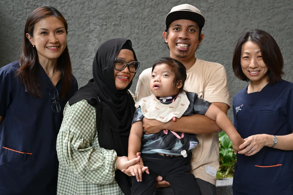 Rania Safiyya Ridzwan, five, is being looked after by a multidisciplinary team, which includes Adjunct Associate Professor Chin Hui-Lin (left) and Associate Professor Ng Kar Hui (right). With them are Rania's parents, Madam Sri Syazwani and Mr Ridzwan Kamis.