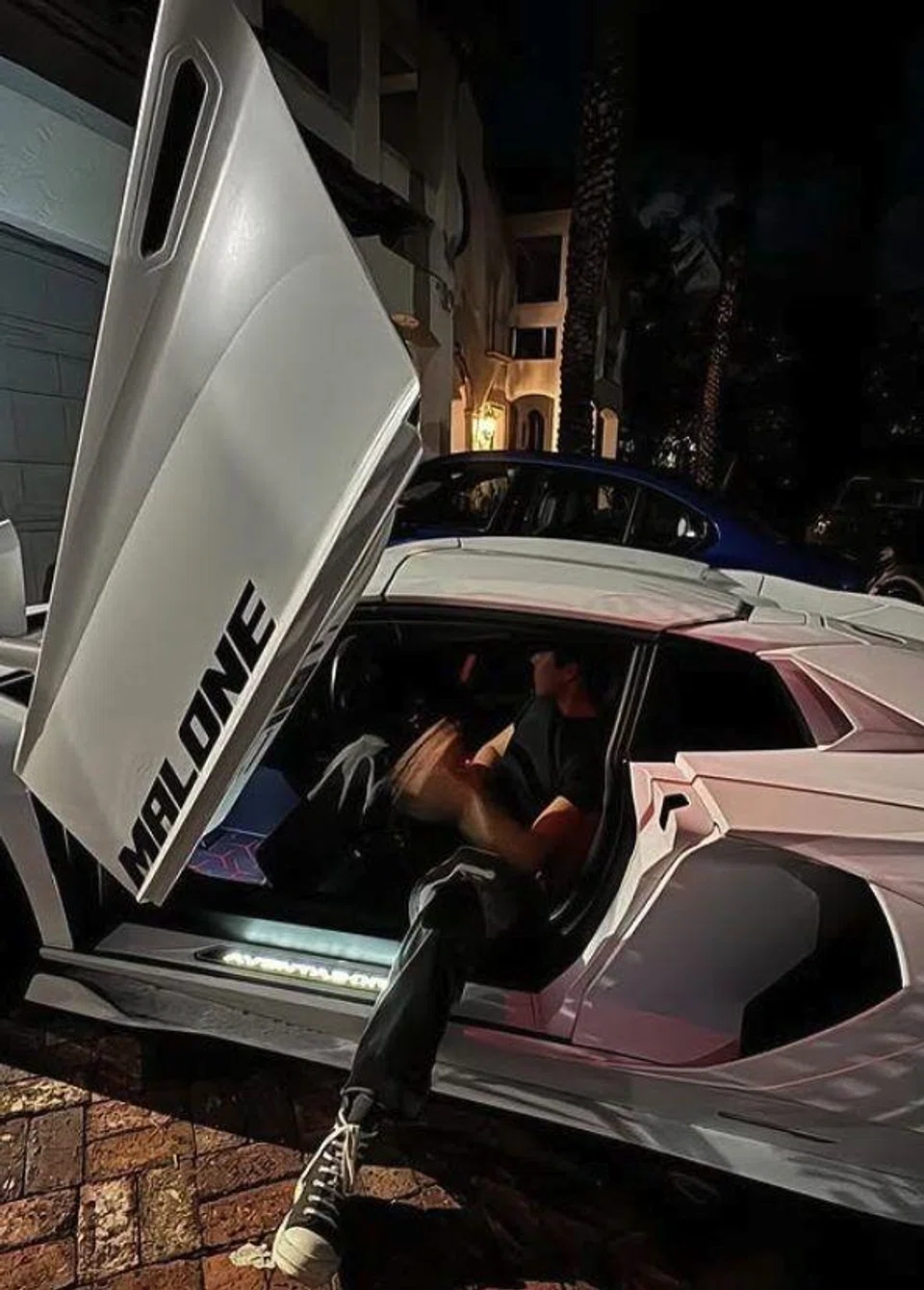 A photo from social media showing Malone Lam Yu Xuan and one of his luxury vehicles.