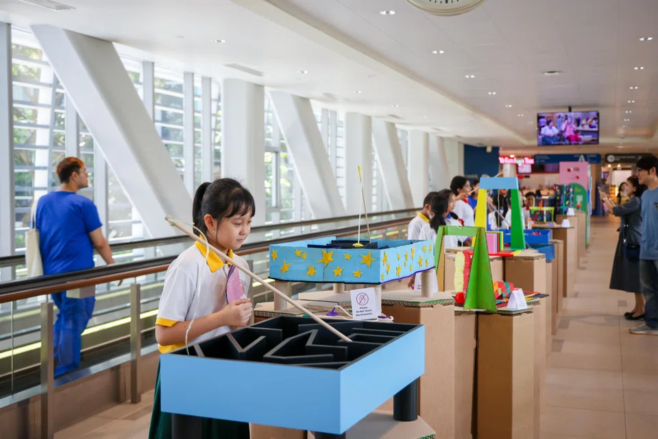 Kaylie Ang, 11, designed Catch The Colour, in which patients use a magnetic rod to guide coloured balls through a maze and collect as many as they can in a minute.