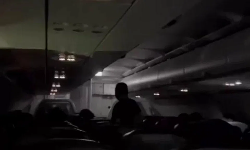 A video of the incident posted by Singapore Incidents at first shows passengers seated in the dark cabin with most of the lights off.