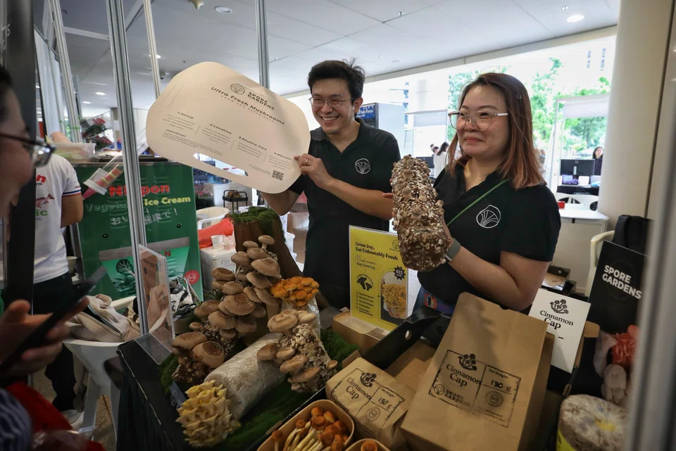 Mr Ong (left) and Ms Audrey Chong, head of marketing of Spore Gardens, travel to different farmers’ markets around Singapore to sell their produce.