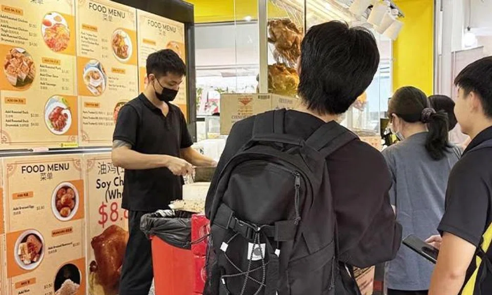 Customers flocking to chicken rice stall for a $1.90 meal.
