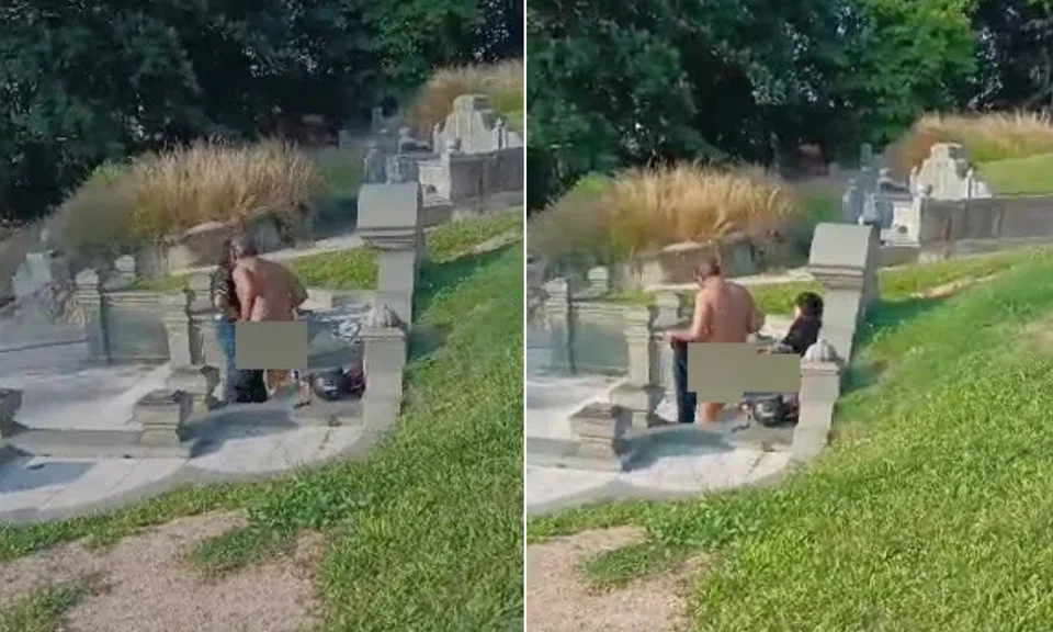 A naked couple were caught engaging in an indecent act at a cemetery in Malaysia.
