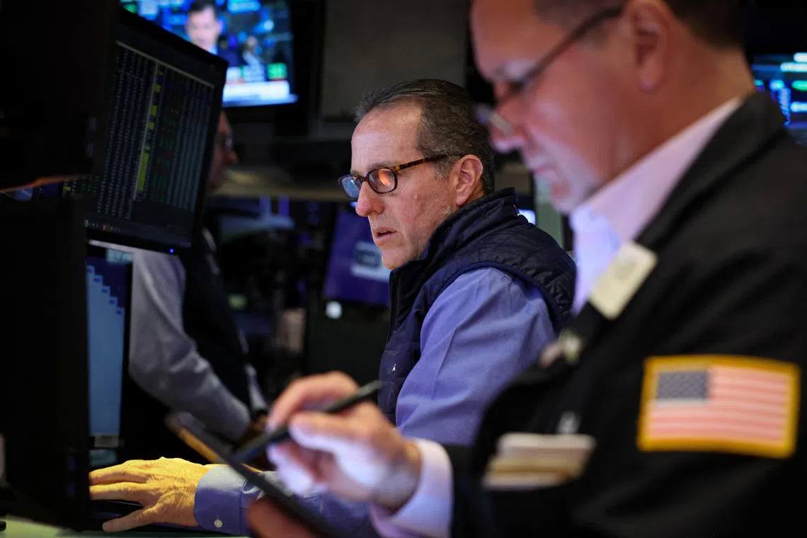 Traders work on the floor of the New York Stock Exchange, in New York City.    