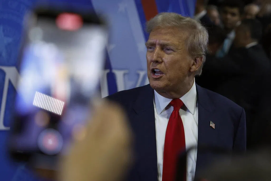 FILE PHOTO: Republican presidential nominee and former U.S. President Donald Trump gestures in the spin room on the day of his debate with Democratic presidential nominee and U.S. Vice President Kamala Harris, in Philadelphia, Pennsylvania, U.S., September 10, 2024. REUTERS/Evelyn Hockstein/File Photo