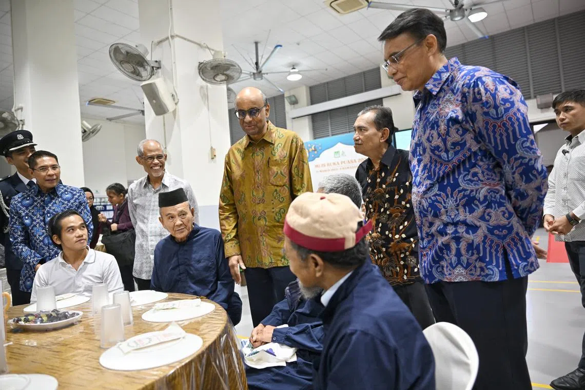 President Tharman Shanmugaratnam (standing, centre) attending a breaking of the fast event at the Singapore Islamic Hub on March 15. Also present are Minister in the Prime Minister’s Office Maliki Osman (left) and Minister-in-charge of Muslim Affairs Masagos Zulkifli (second from left).