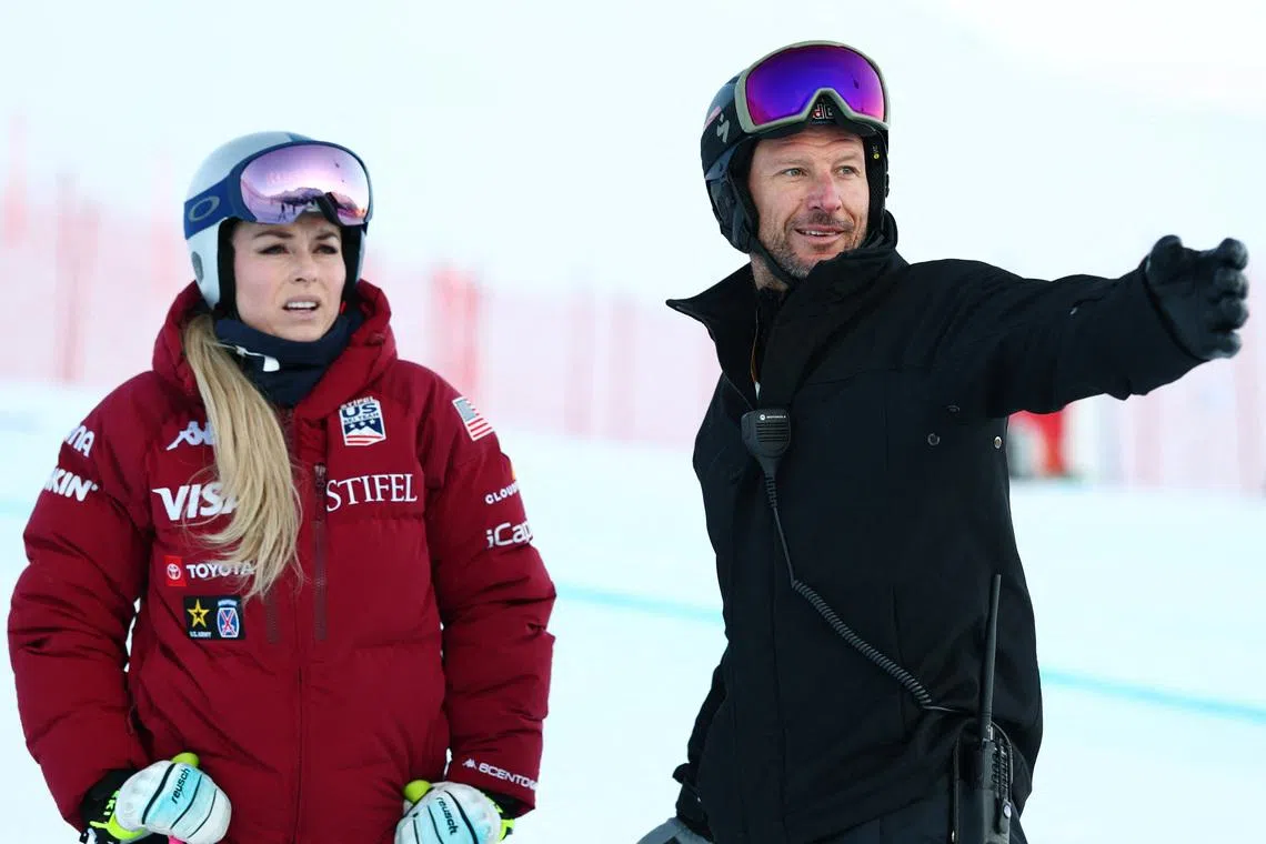 Alpine Skiing - FIS Alpine Ski World Cup - Women's Super G - St. Moritz, Switzerland - December 14, 2025 Lindsey Vonn of the U.S. with coach Aksel Lund Svindal during practice before the Women's Super G REUTERS/Denis Balibouse