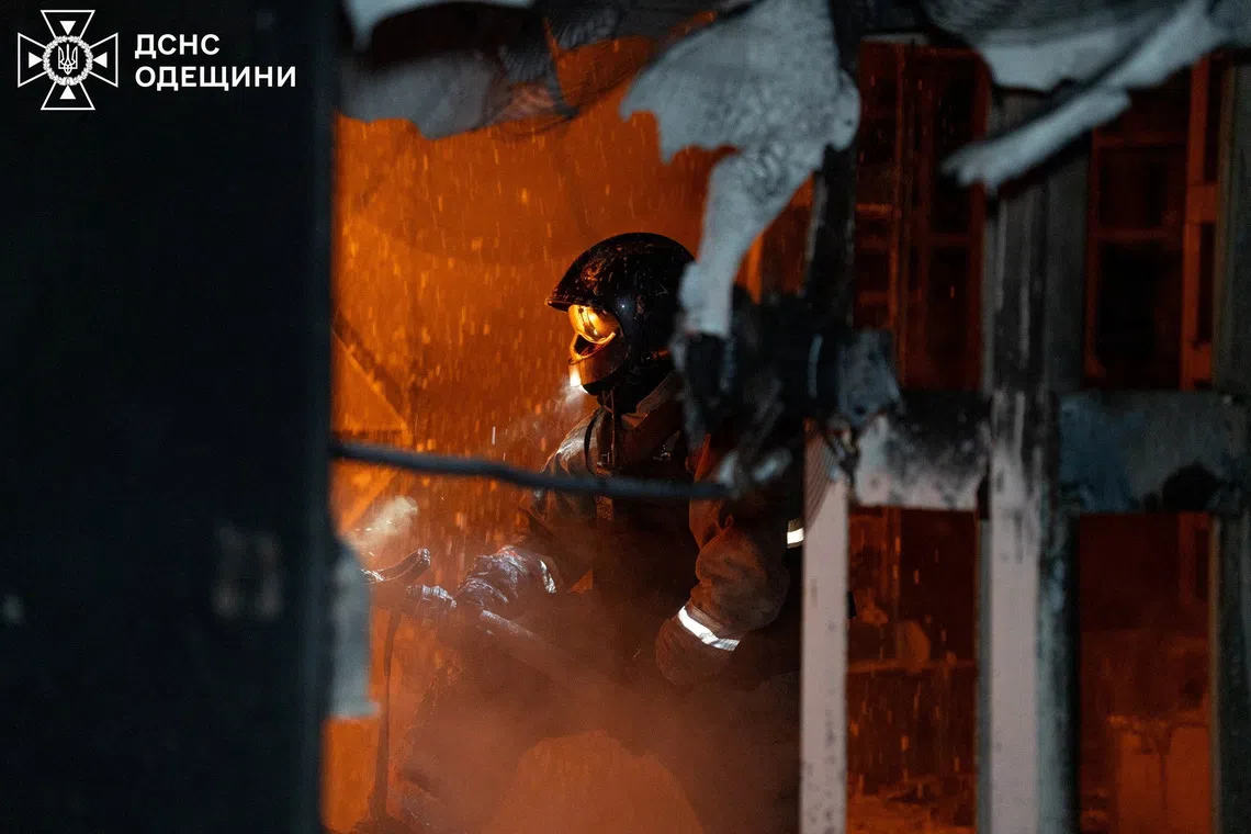 A firefighter works at the site of a Russian drone strike, amid Russia's attack on Ukraine, in Odesa, Ukraine, in this handout picture released December 4, 2025. Press service of the State Emergency Service of Ukraine in Odesa region/Handout via REUTERS