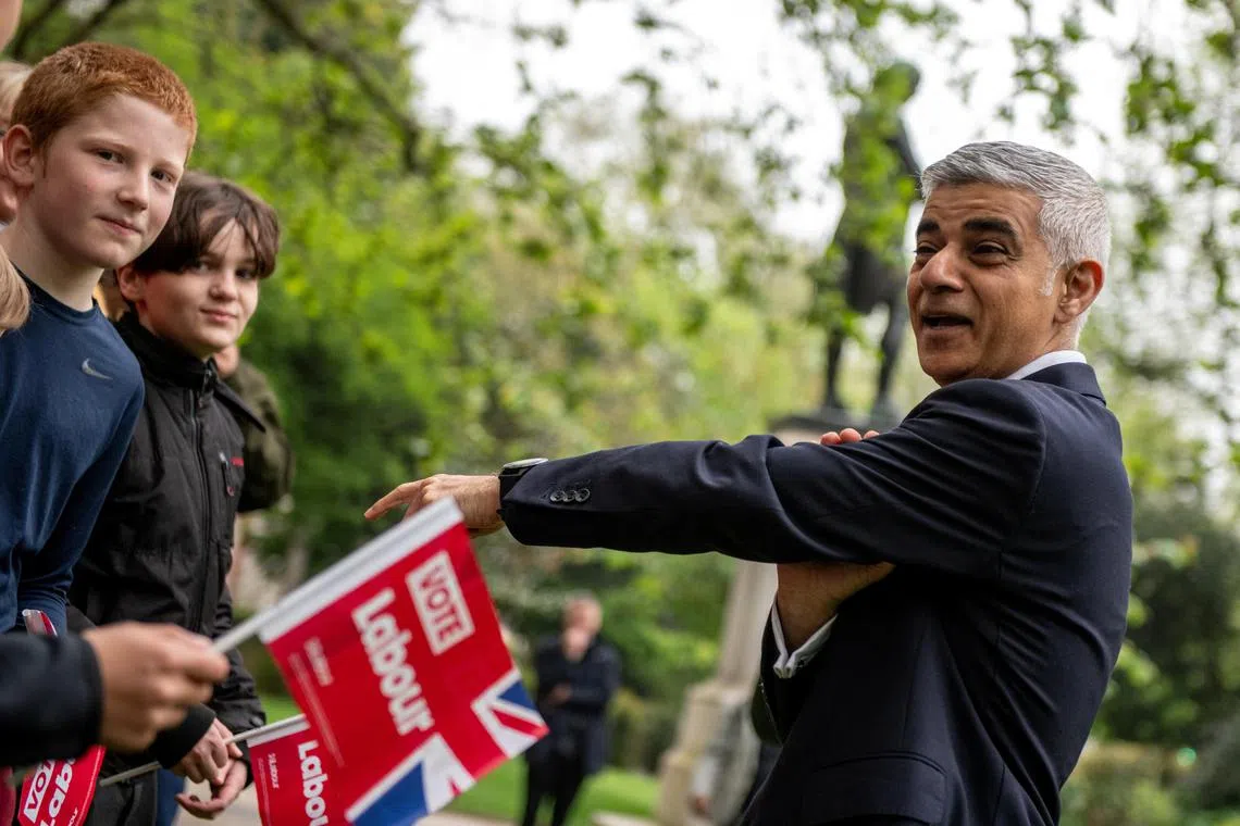 Mayor of London Sadiq Khan reacts during a photo-call with supporters the day before voters go to the polls in the London Mayoral elections in London, Britain May 1, 2024. REUTERS/Chris J. Ratcliffe