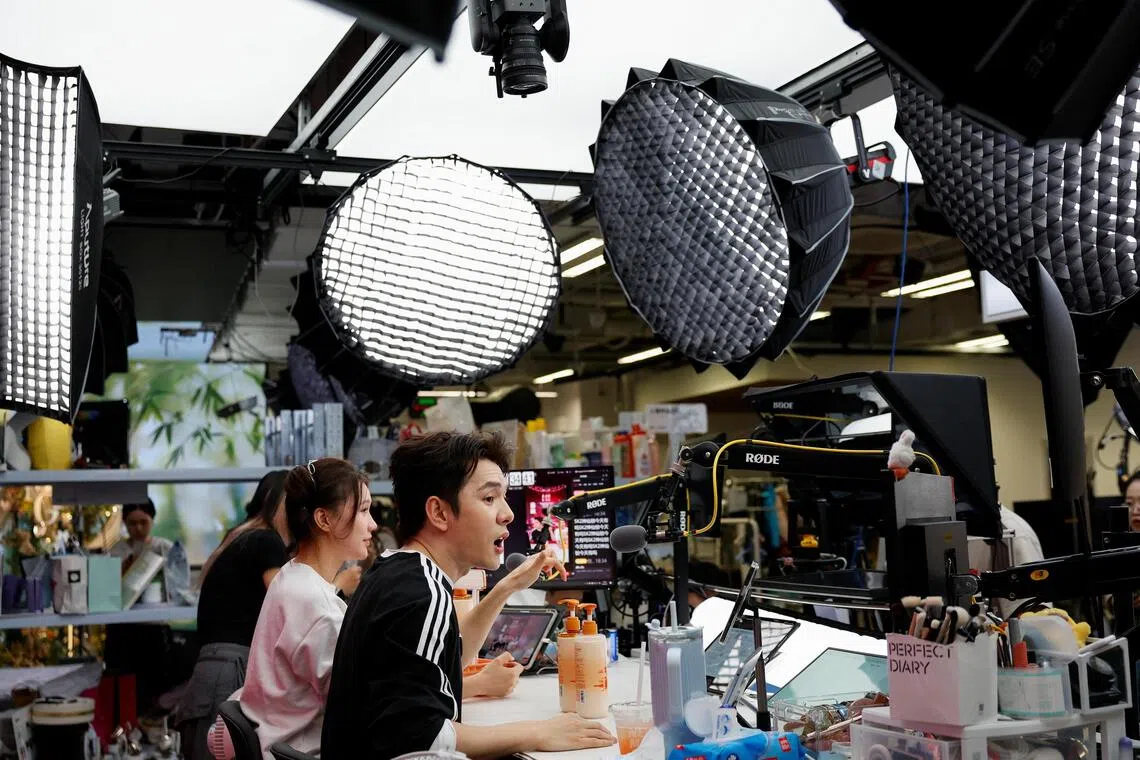 Livestreamer Li Jiaqi (in black top) is famed for selling billions of dollars worth of beauty products to more than 100 million followers.