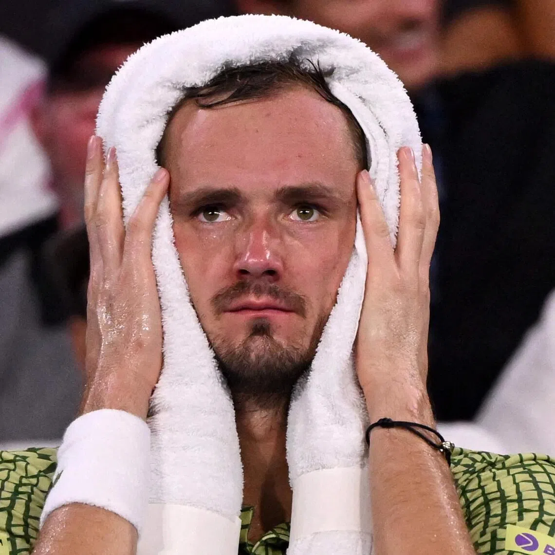 Daniil Medvedev of Russia places an ice towel on his head during his 6-2, 7-6 (7-1) win over Brandon Nakashima of the US in the final of the Brisbane International tennis tournament on Jan 11, 2026. 