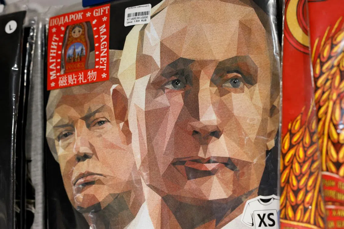 T-shirts with images of Presidents Vladimir Putin and Donald Trump are displayed at a Moscow gift shop.