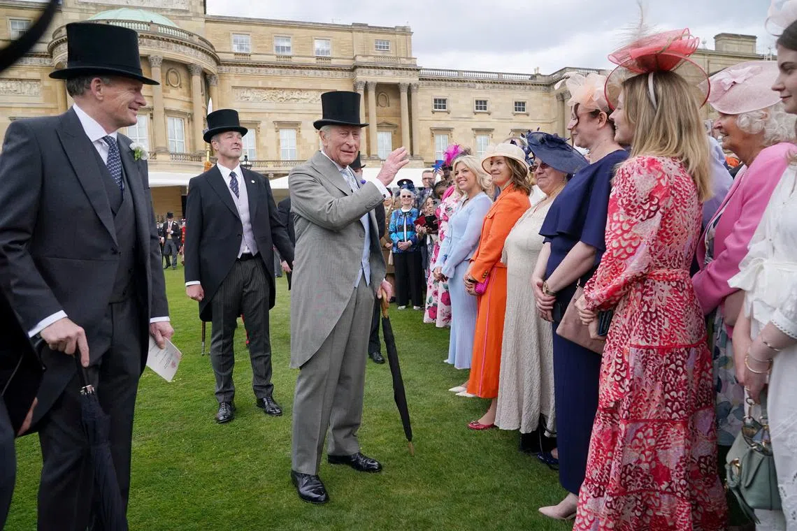 King Charles III speaks to guests during a Royal Garden Party at Buckingham Palace, in London, Britain May 7, 2025. Yui Mok/Pool via REUTERS