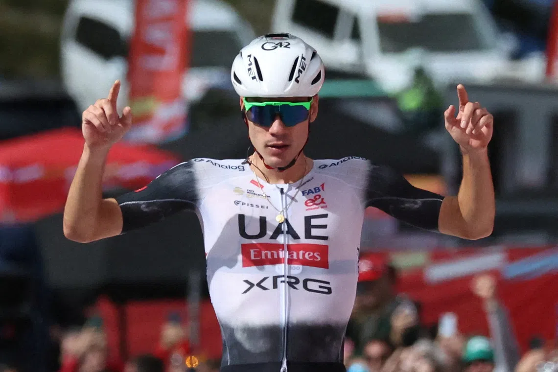 FILE PHOTO: Cycling - Vuelta a Espana - Stage 7 - Andorra la Vella to Cerler - Andorra la Vella, Andorra - August 29, 2025 UAE Team Emirates XRG's Juan Ayuso crosses the finish line to win stage 7 REUTERS/Bruna Casas/File Photo