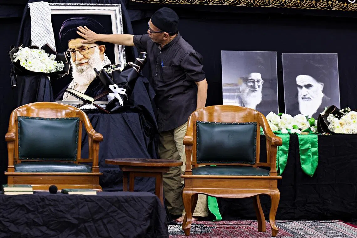 An Indonesian Muslim man mourns the death of Iran's Supreme Leader Ayatollah Ali Khamenei at the Islamic Cultural Center in Jakarta.