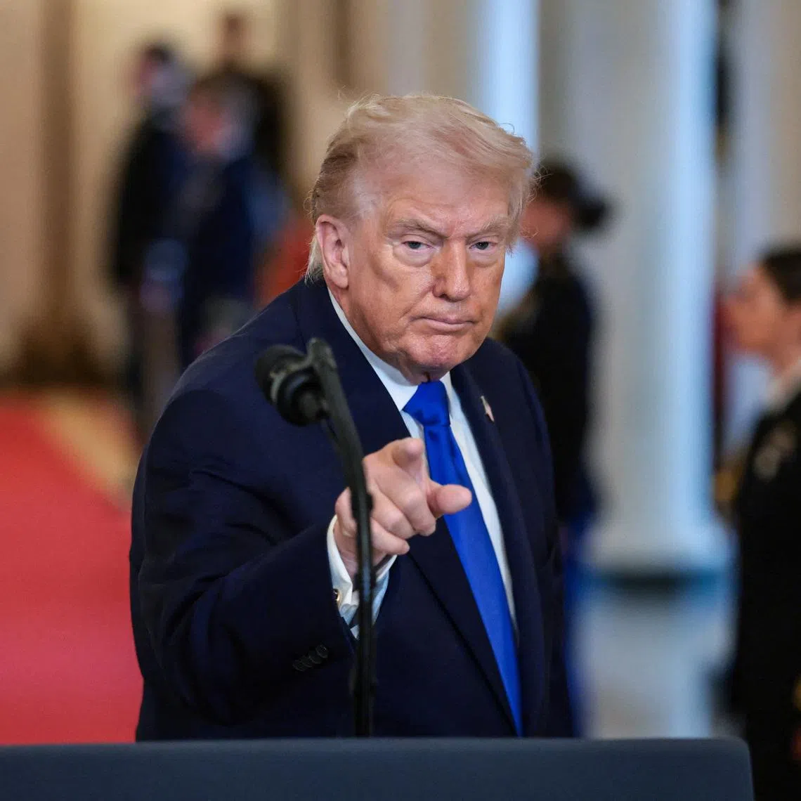 U.S. President Donald Trump gestures at the end of an event to honor \"Angel Families\" who have lost family members to crimes committed by people in the country illegally, at the White House in Washington, D.C., U.S., February 23, 2026. REUTERS/Evelyn Hockstein